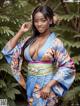 A woman in a blue kimono posing for a picture.