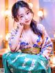 A woman in a kimono sitting on a table.